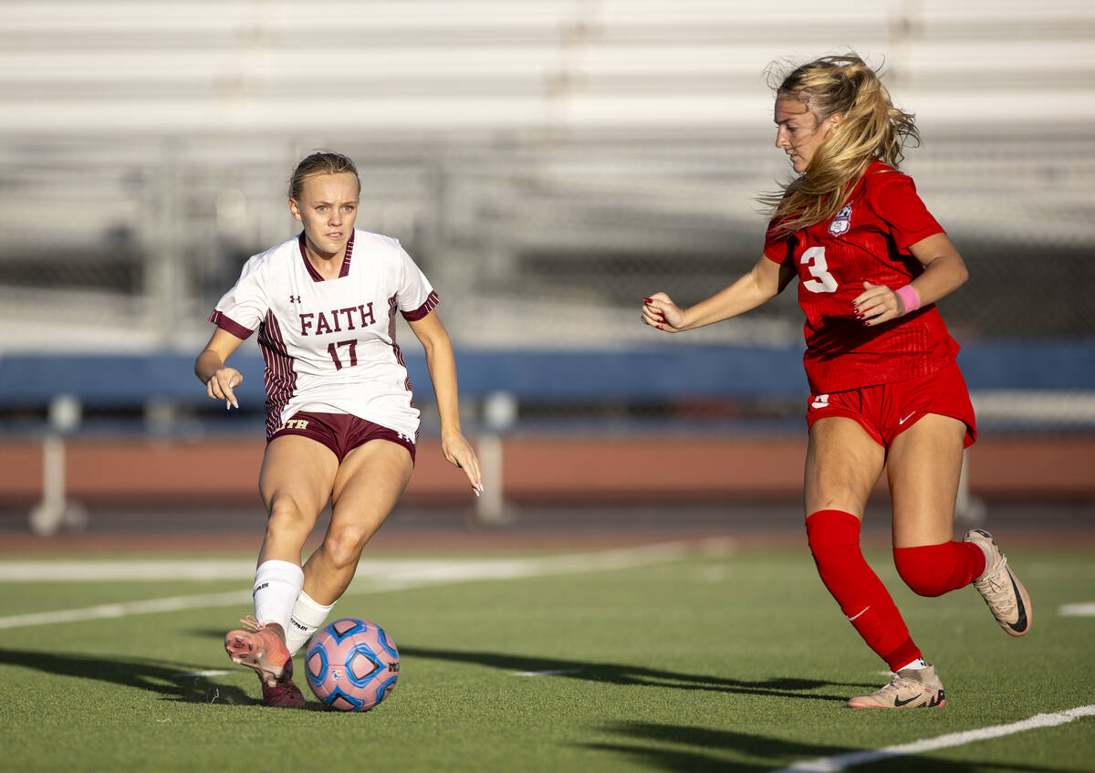 Faith Lutheran sophomore Julia Anfinson (17) passes the ball during the high school soccer game ...