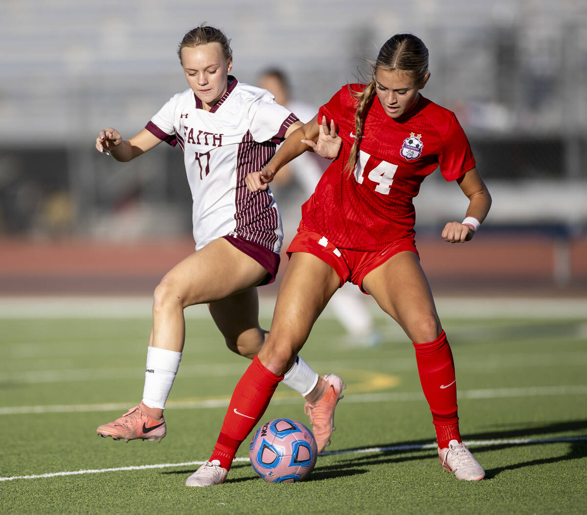 Faith Lutheran sophomore Julia Anfinson (17) and Coronado midfielder Allison Kleiner (14) compe ...