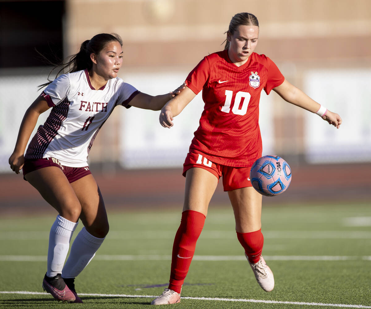 Coronado midfielder Ryan Neel (10) and Faith Lutheran midfielder Ana Coe (11) compete for the b ...