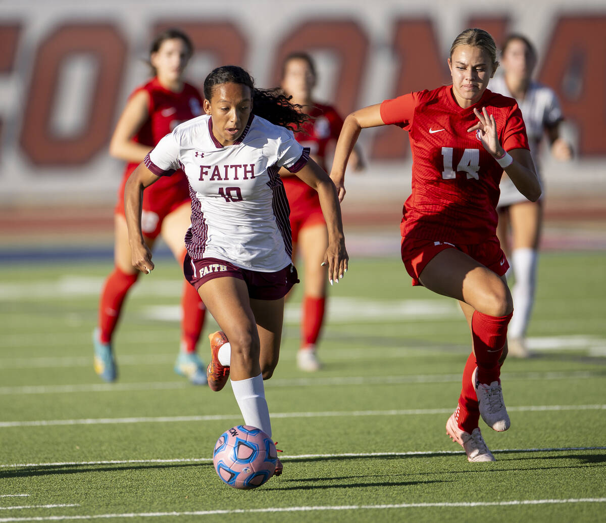 Faith Lutheran forward Briana Lee (10) and Coronado midfielder Allison Kleiner (14) compete for ...