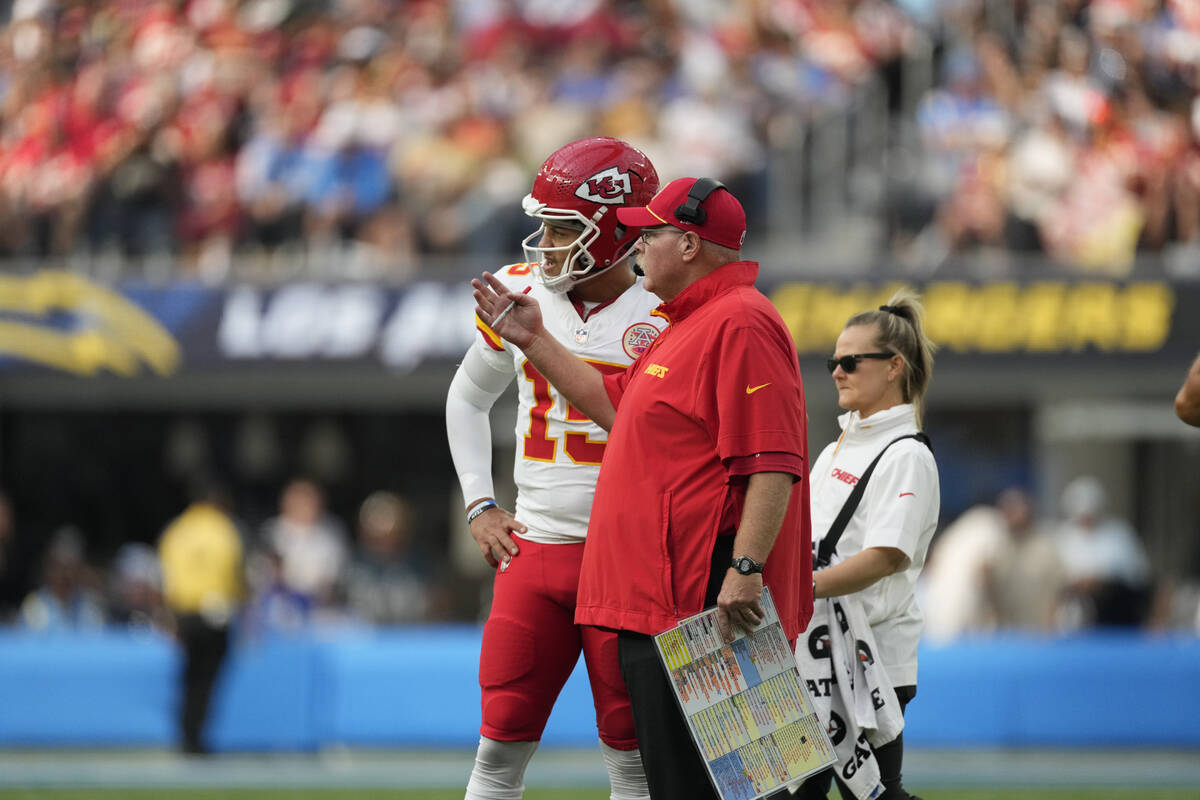 Kansas City Chiefs quarterback Patrick Mahomes, left, talks with head coach Andy Reid during th ...