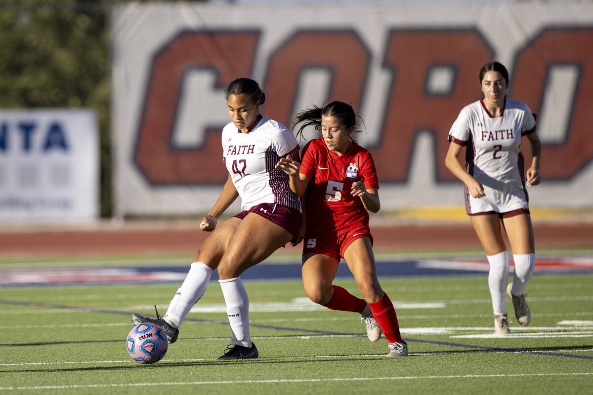 Faith Lutheran midfielder Jailynn Henry (42) and Coronado forward Abby Obregon (5) compete for ...