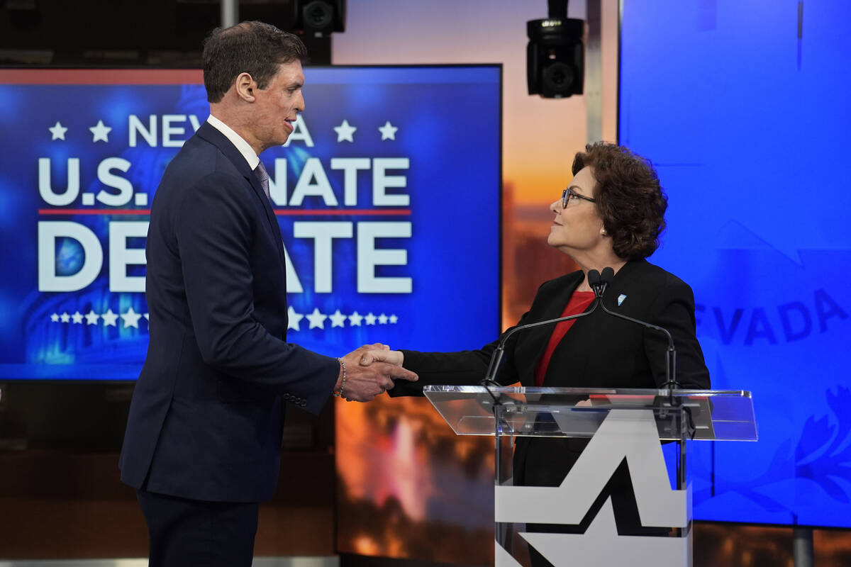 Republican Senate candidate Sam Brown, left, and Sen. Jacky Rosen, D-Nev., shake hands before a ...