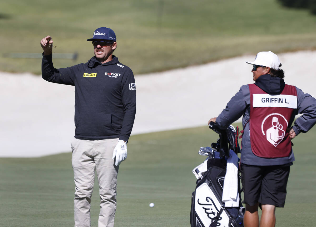 Lanto Griffin sprinkles grasses to determine the direction of the wind as he prepares to hit fr ...