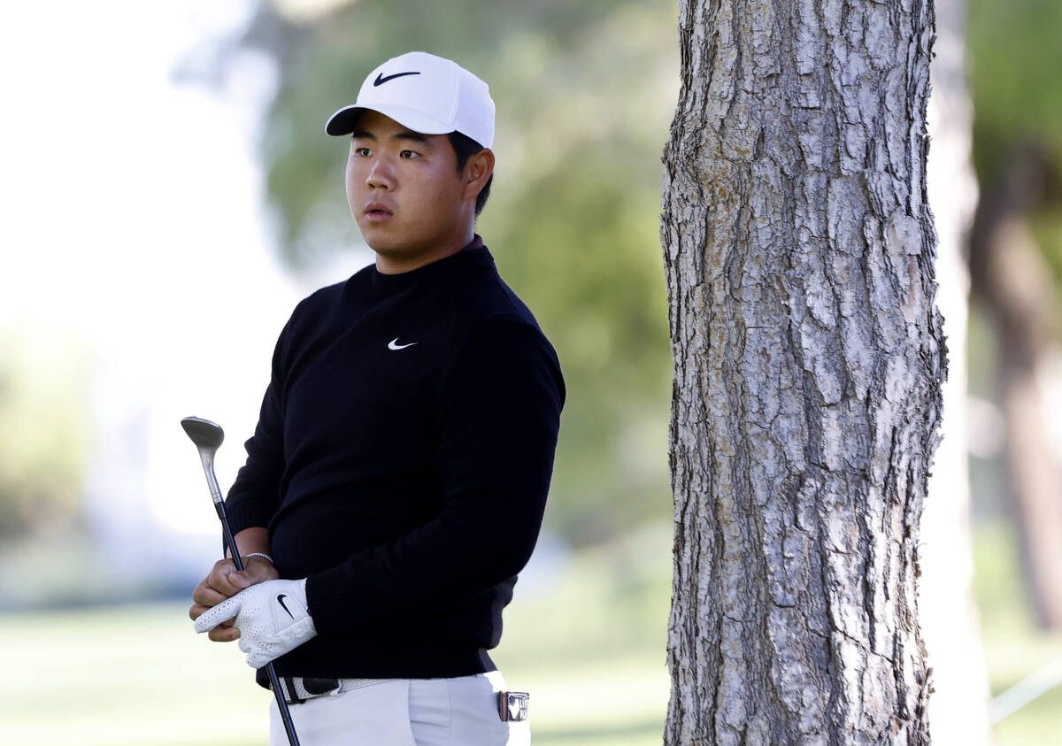 Tom Kim watches after playing an approach shot from the 9th fairway during the second round of ...