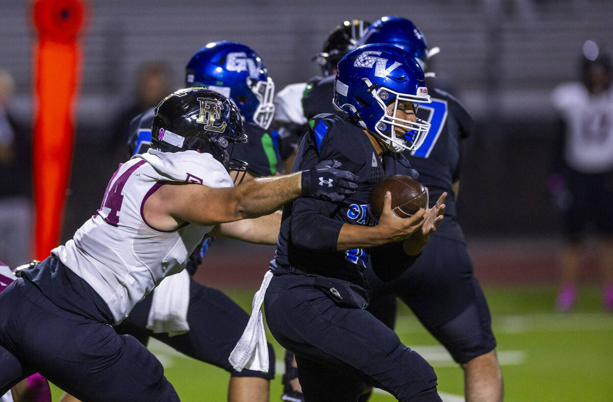 Green Valley quarterback Michael Lewis (15) is stopped again by Faith Lutheran defensive linema ...