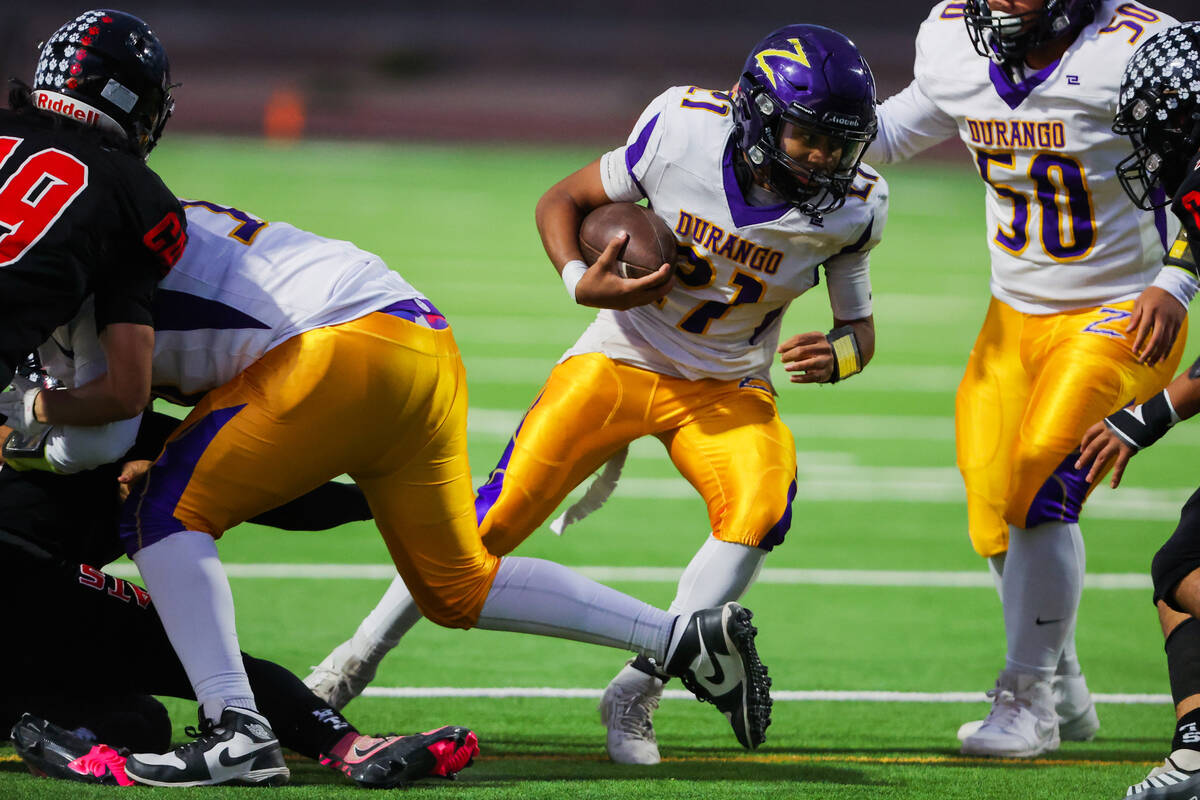 Durango running back Makai Miller (21) runs the ball during a high school football game between ...