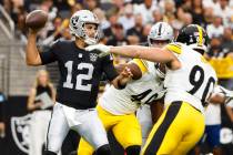 Raiders quarterback Aidan O'Connell (12) throws under pressure from Pittsburgh Steelers linebac ...