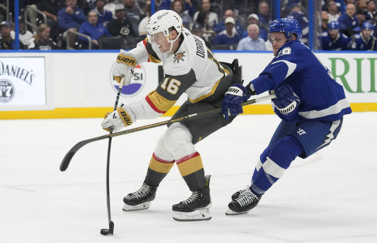 Tampa Bay Lightning center Jake Guentzel (59) hooks Vegas Golden Knights left wing Pavel Dorofe ...