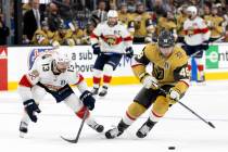 Golden Knights center Ivan Barbashev (49) steals the puck from Florida Panthers center Sam Rein ...