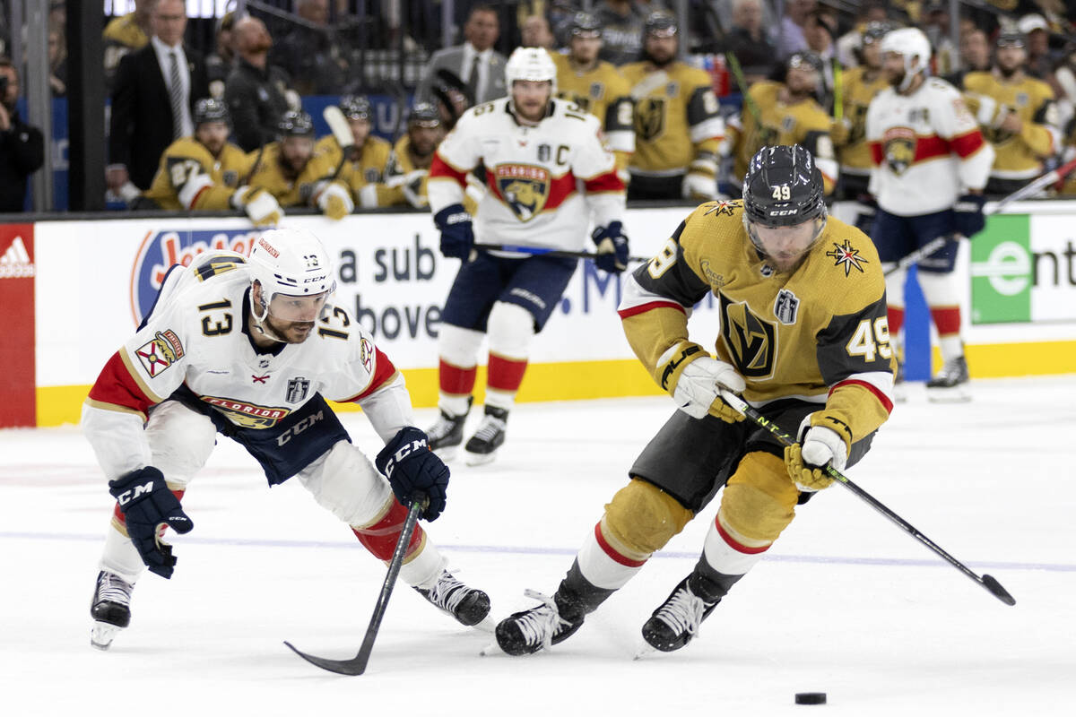 Golden Knights center Ivan Barbashev (49) steals the puck from Florida Panthers center Sam Rein ...