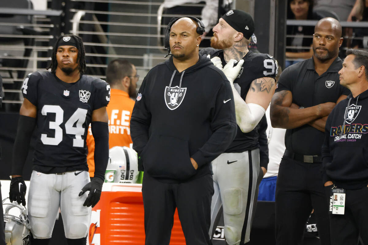 Raiders head coach Antonio Pierce and defensive end Maxx Crosby (98) safety Thomas Harper (34) ...