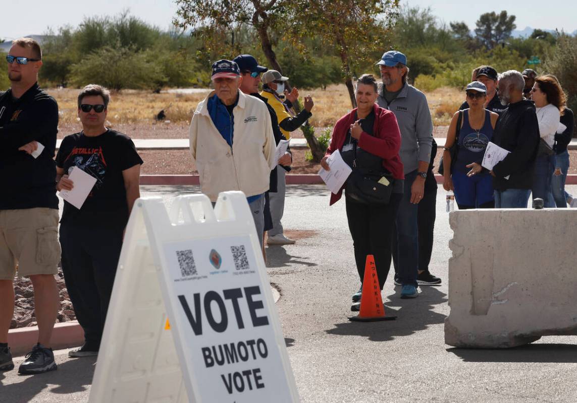 People line up to cast their vote during early voting at Thunderbird Family Sports Complex, on ...