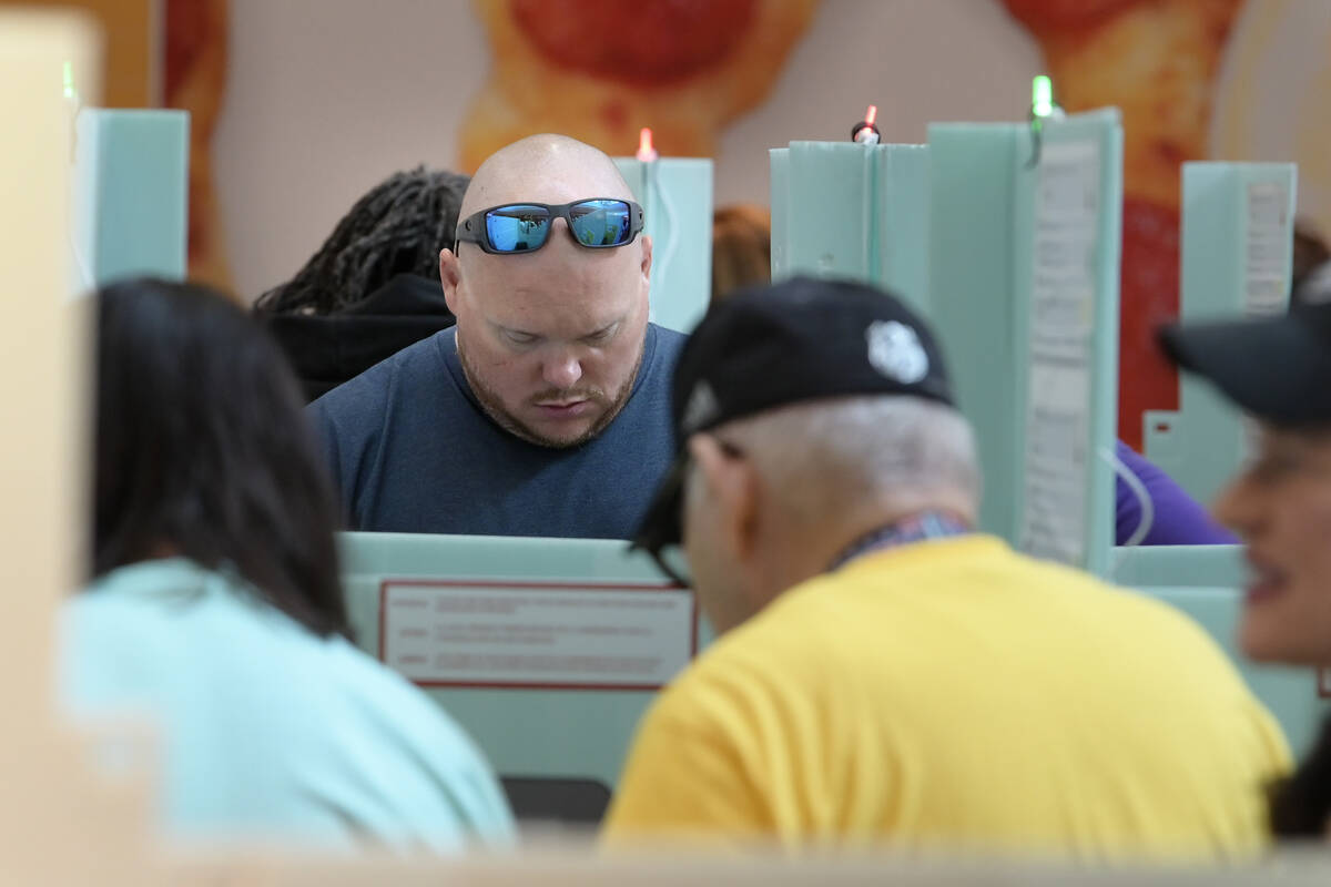 Jason Schmidt casts his ballot at the Galleria Mall in Henderson during early voting Saturday, ...