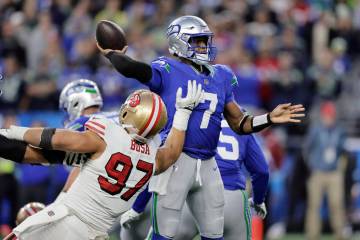 Seattle Seahawks quarterback Geno Smith (7) passes under pressure from San Francisco 49ers defe ...