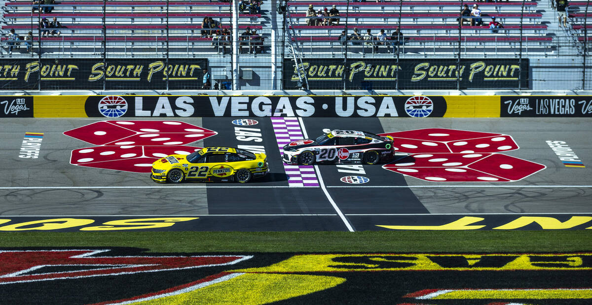 Joey Logano (22) and Christopher Bell (20) pass the start/finish line during the NASCAR Cup Ser ...