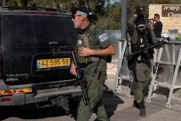 Israeli security forces secure a road near where Israel's government says a drone launched towa ...