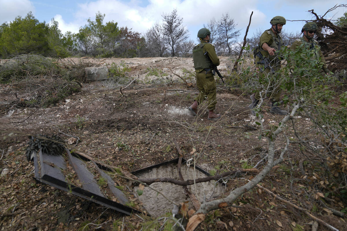 Israeli soldiers display what they say is an entrance to a Hezbollah tunnel found during their ...