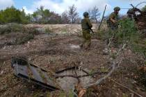 Israeli soldiers display what they say is an entrance to a Hezbollah tunnel found during their ...