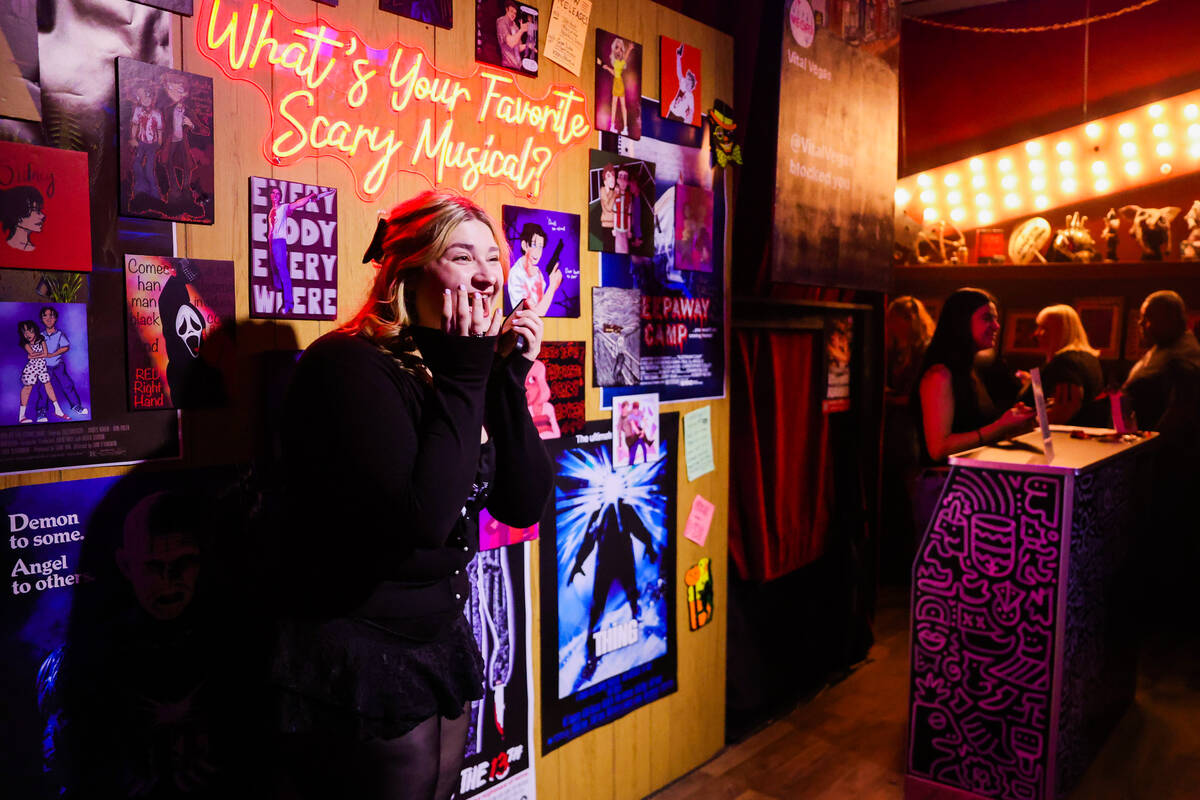 Lauren Jolley poses in front of a wall decorated with “Scream” artwork before seeing a perf ...