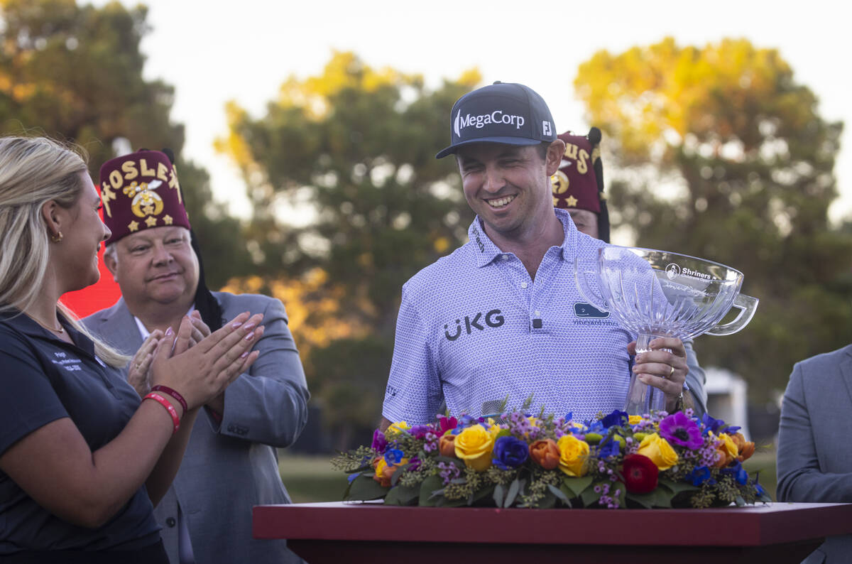 J.T. Poston holds the trophy after winning the Shriners Children’s Open at TPC Summerlin ...