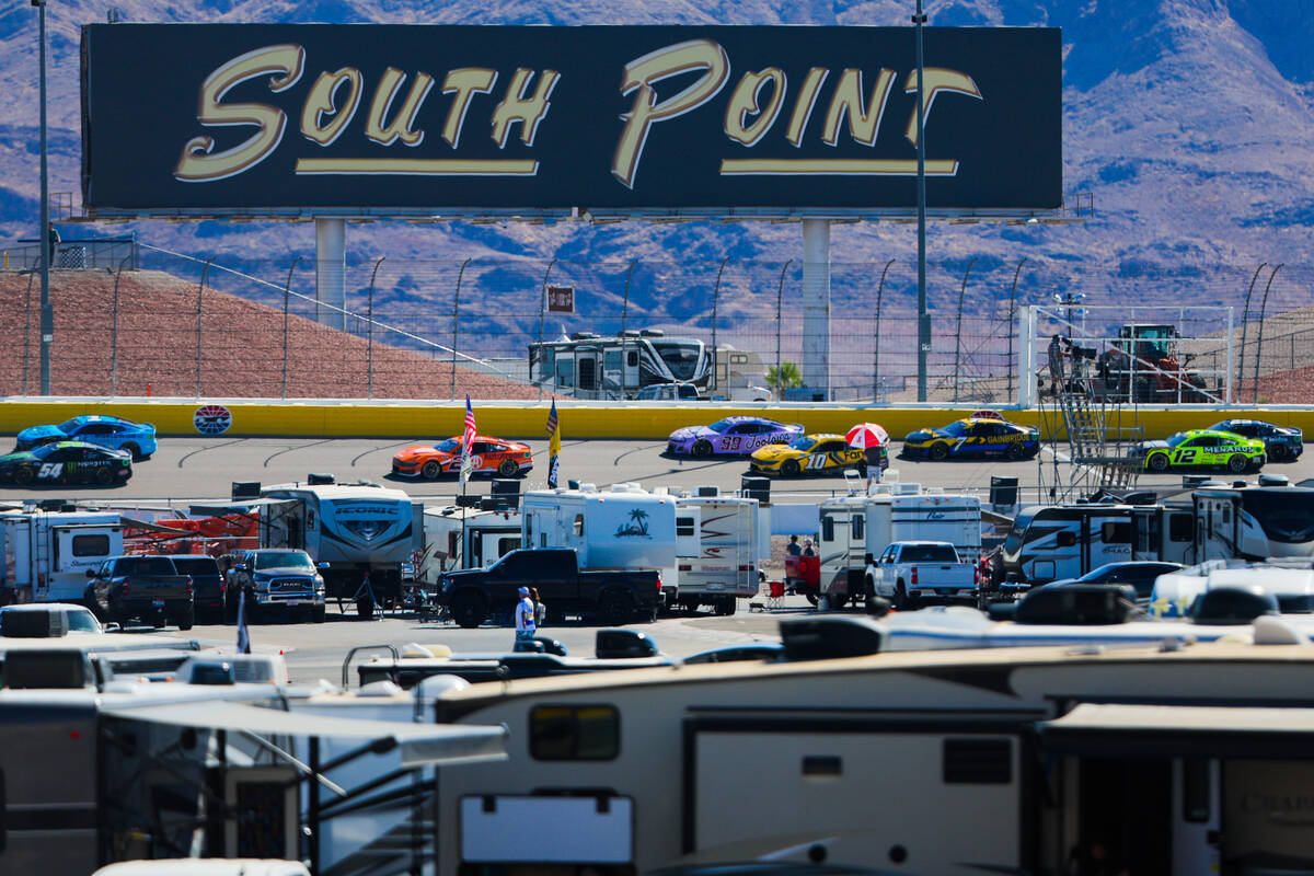 NASCAR drivers speed through the backstretch during the South Point 400 NASCAR Cup Series race ...