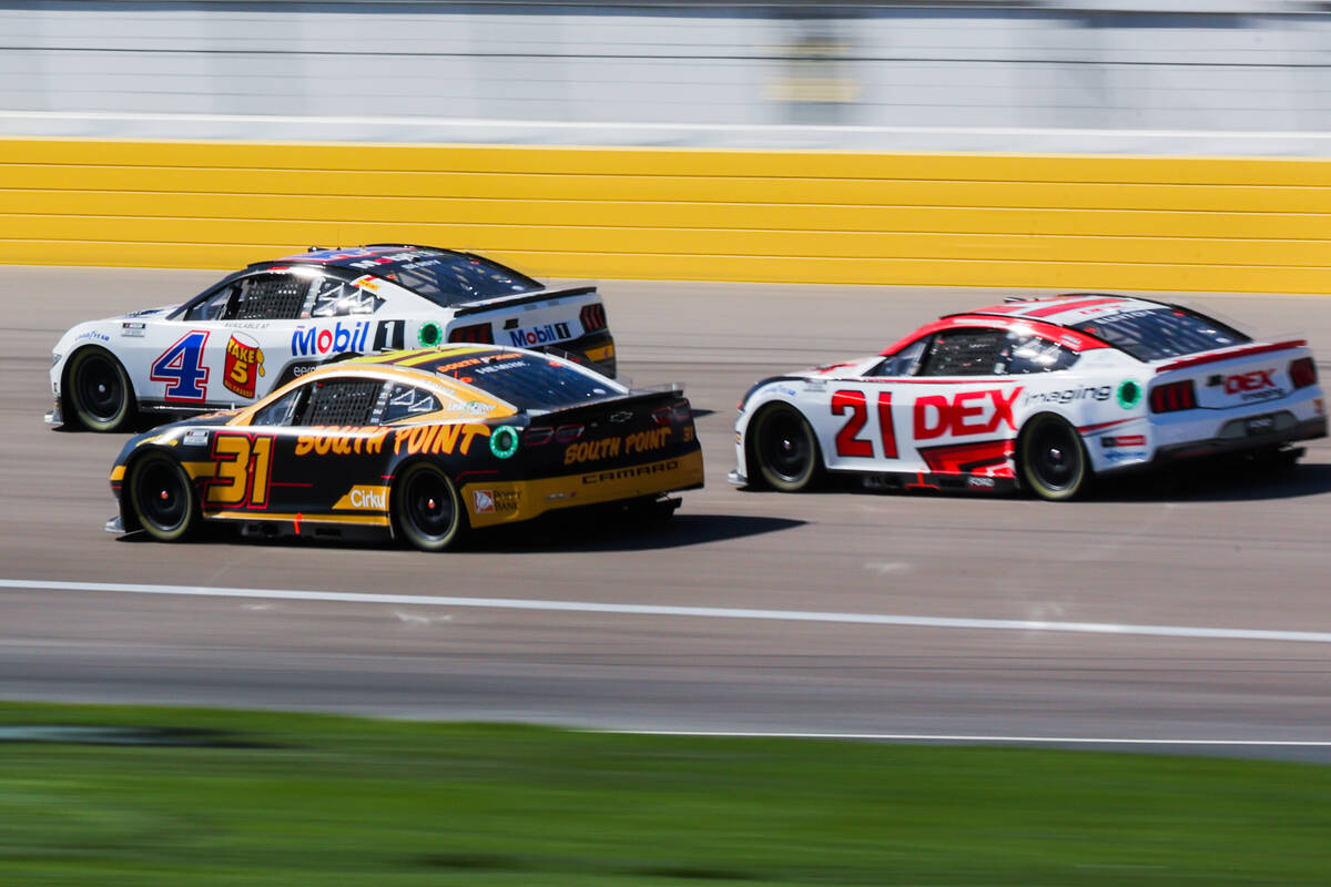 NASCAR drivers speed through the backstretch during the South Point 400 NASCAR Cup Series race ...