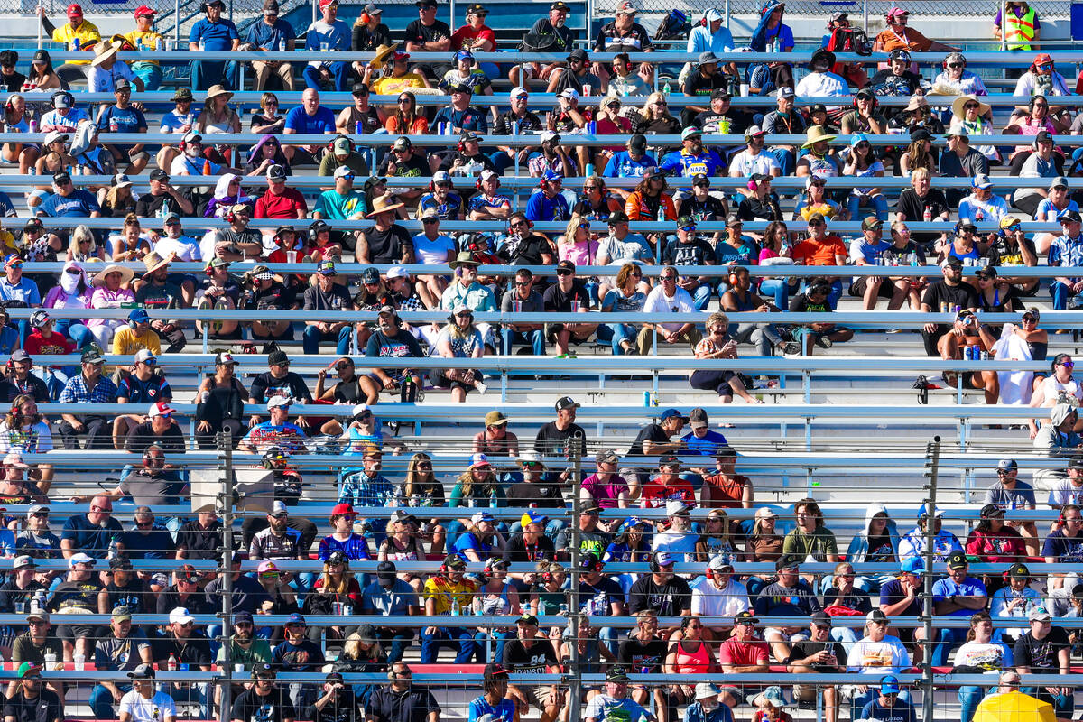 NASCAR fans watch race action in the bleachers during the South Point 400 NASCAR Cup Series rac ...