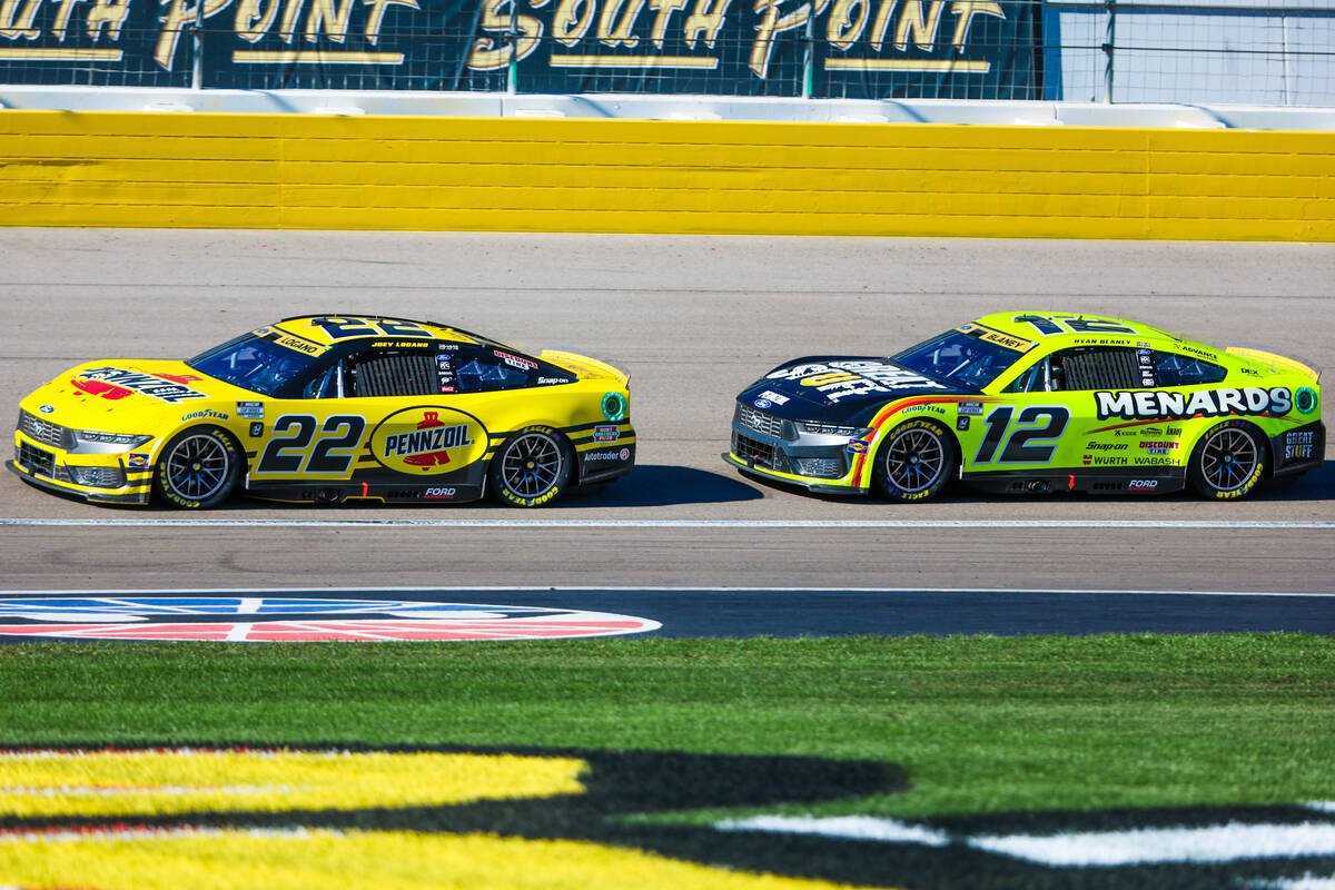 NASCAR driver Joey Logano (22) leads as Ryan Blaney (12) closely trails him during the South Po ...