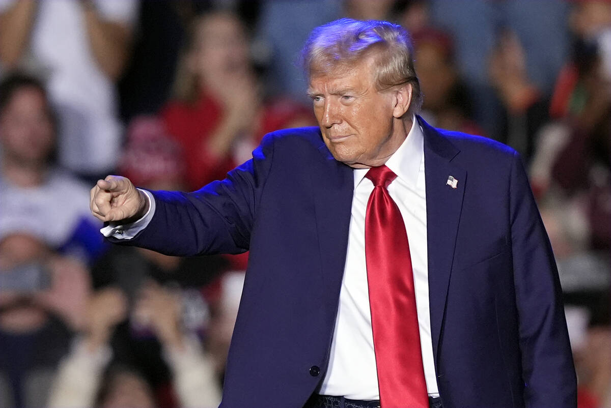 Republican presidential nominee former President Donald Trump gestures at a campaign event, Fri ...