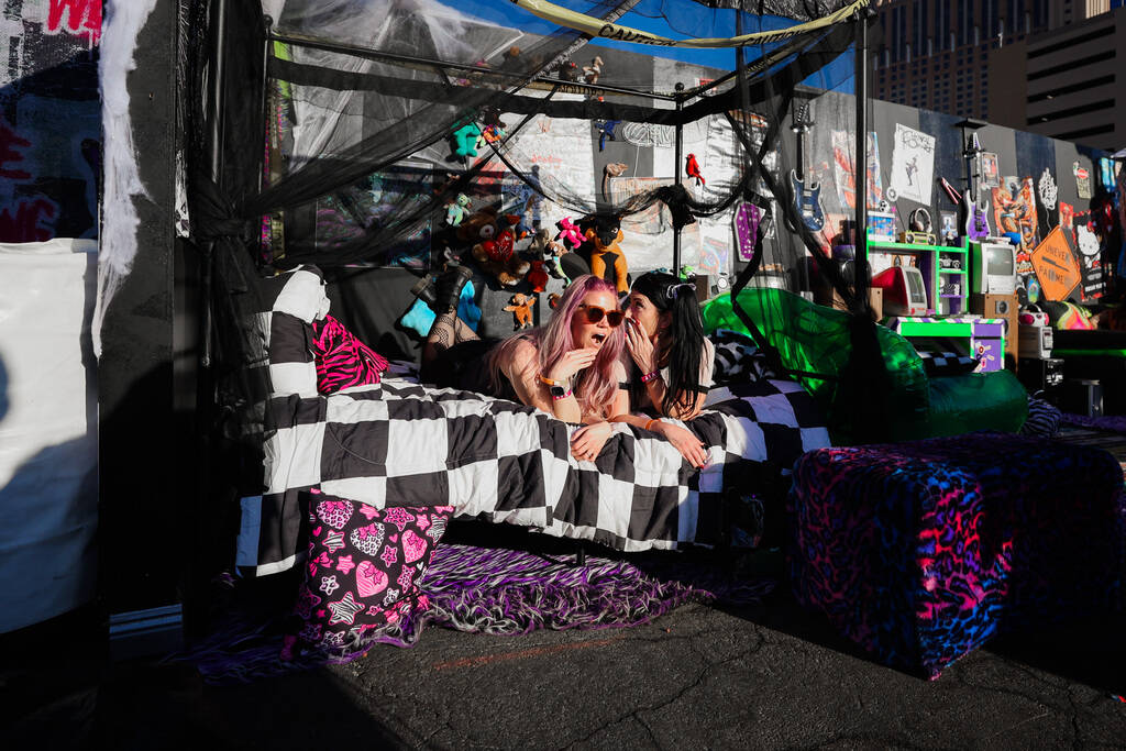 Festival attendees pose inside of a fake bedroom during the When We Were Young music festival a ...