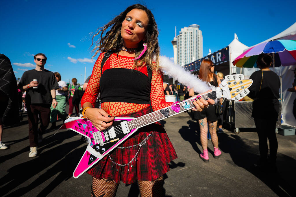 Kasey Allen plays a fake guitar during the When We Were Young music festival at the Las Vegas F ...