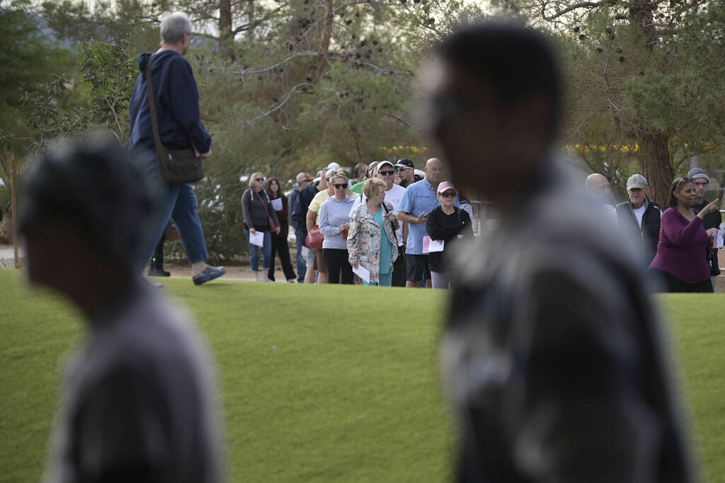 Voters line up outside the Silverado Ranch Community Center to take part in early voting Saturd ...