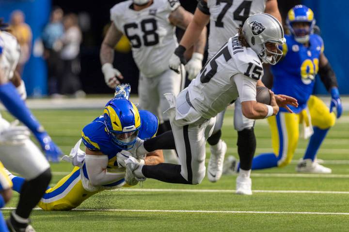 Raiders quarterback Gardner Minshew (15) is sacked by Los Angeles Rams linebacker Michael Hoech ...