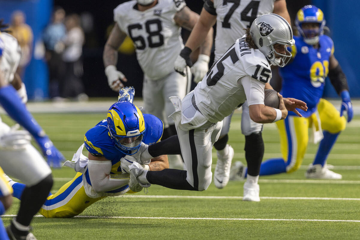 Raiders quarterback Gardner Minshew (15) is sacked by Los Angeles Rams linebacker Michael Hoech ...