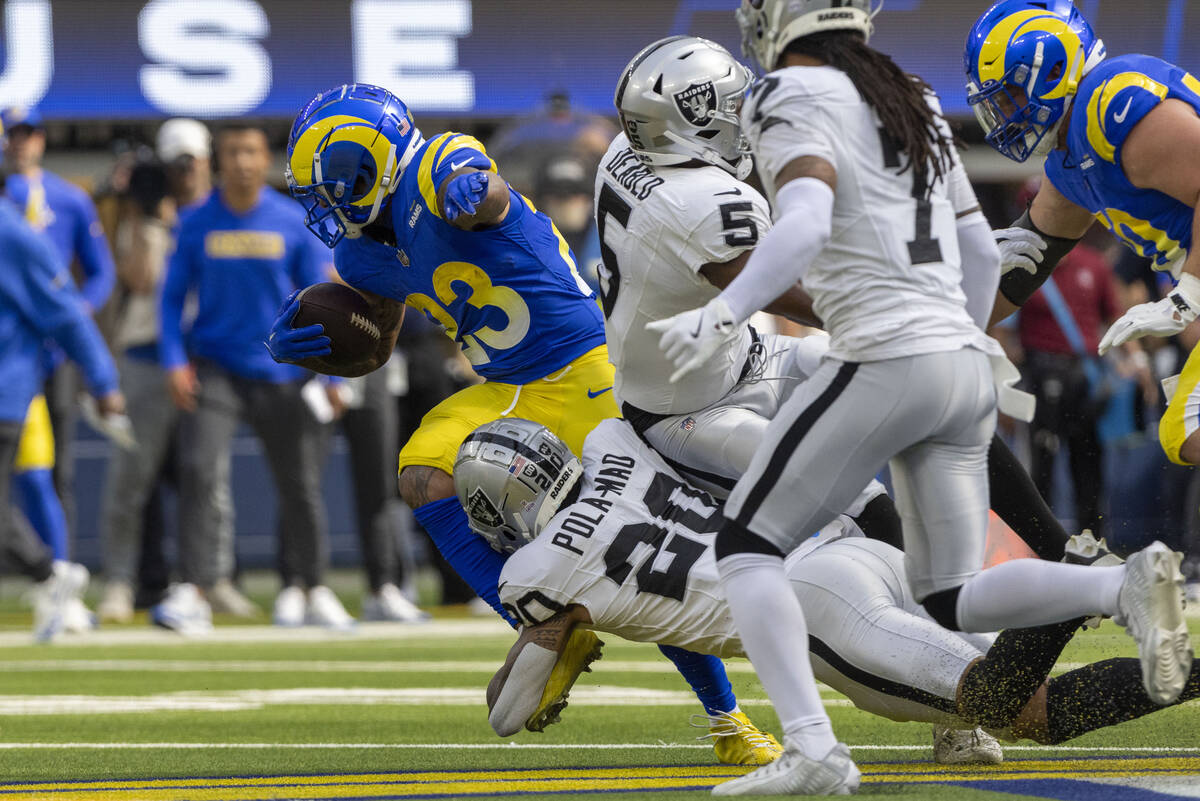 Raiders safety Isaiah Pola-Mao (20) tackles Los Angeles Rams running back Kyren Williams (23) d ...