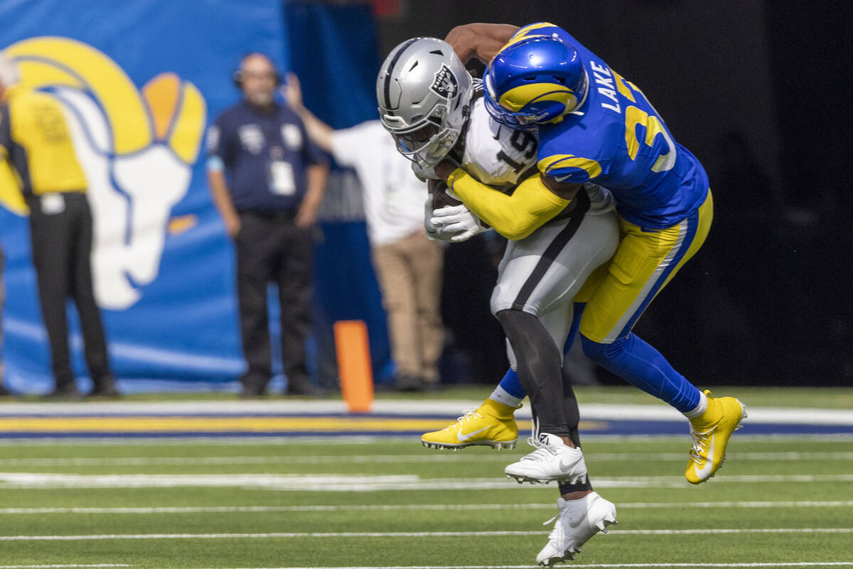 Raiders wide receiver DJ Turner (19) is tackled by Los Angeles Rams safety Quentin Lake (37) du ...