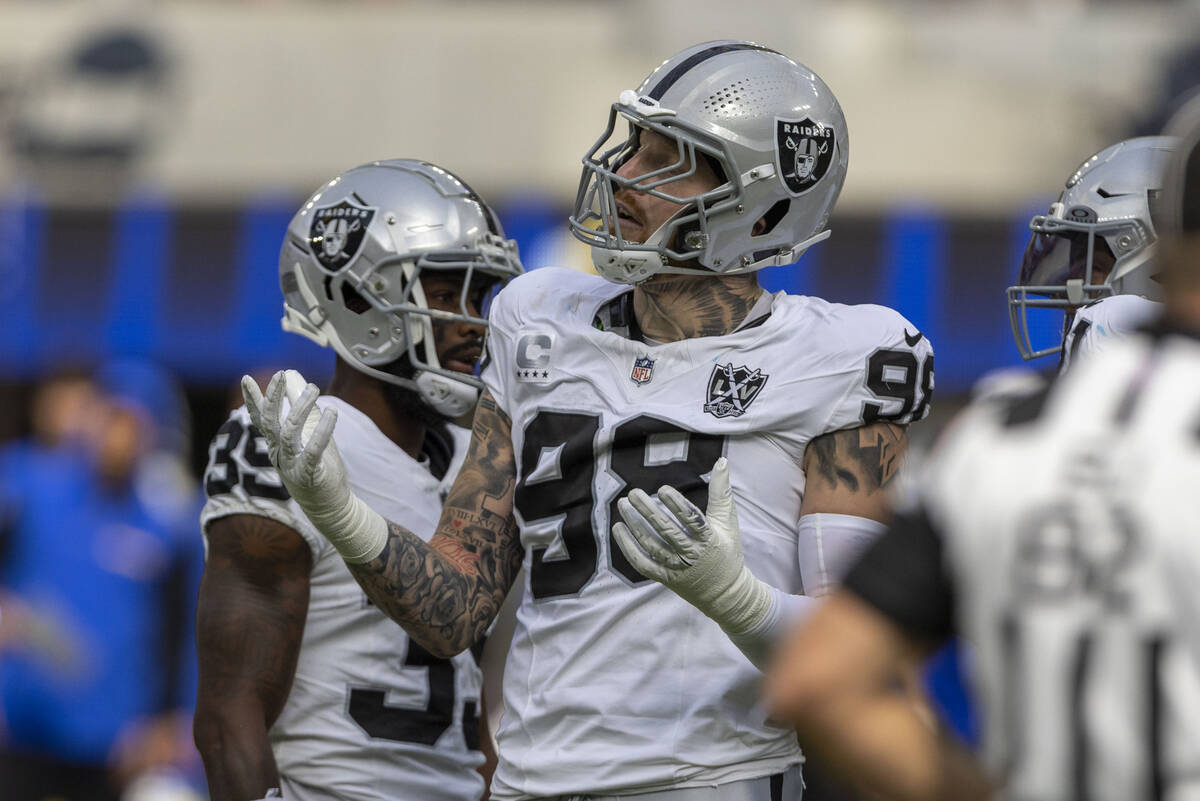 Raiders defensive end Maxx Crosby (98) reacts after being called for roughing the passer on Los ...