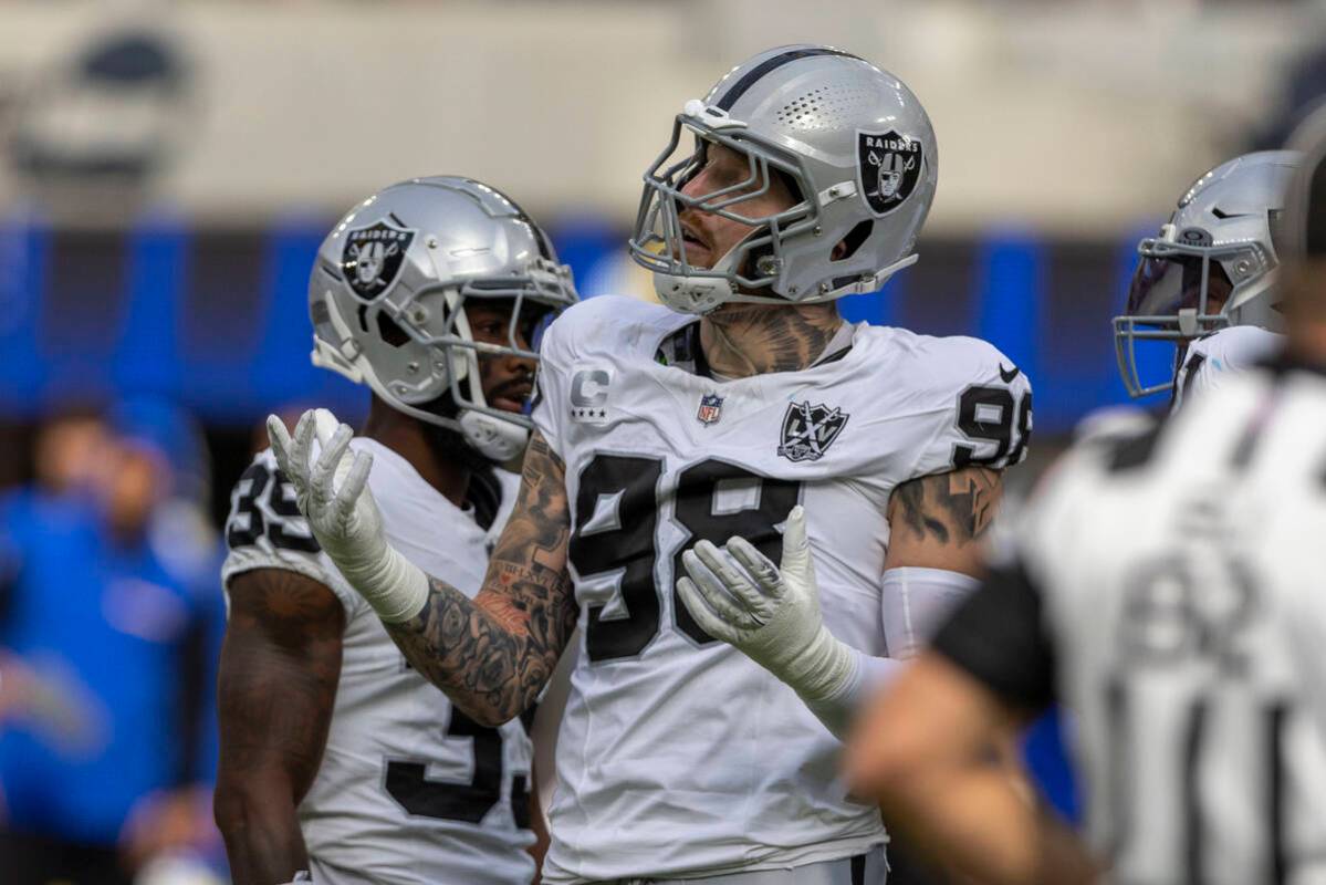 Raiders defensive end Maxx Crosby (98) reacts after being called for roughing the passer on Los ...