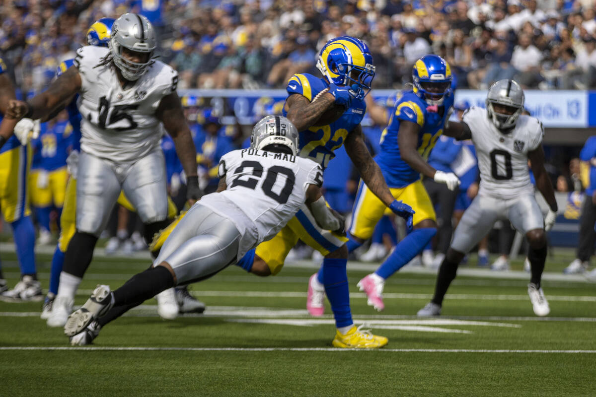 Los Angeles Rams running back Kyren Williams (23) escapes a tackle by Raiders safety Isaiah Pol ...