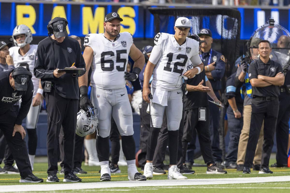 Raiders guard Cody Whitehair (65) and Raiders quarterback Aidan O'Connell (12) look on from the ...