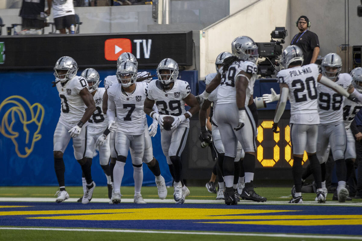 Raiders cornerback Nate Hobbs (39) celebrates his interception of Los Angeles Rams quarterback ...