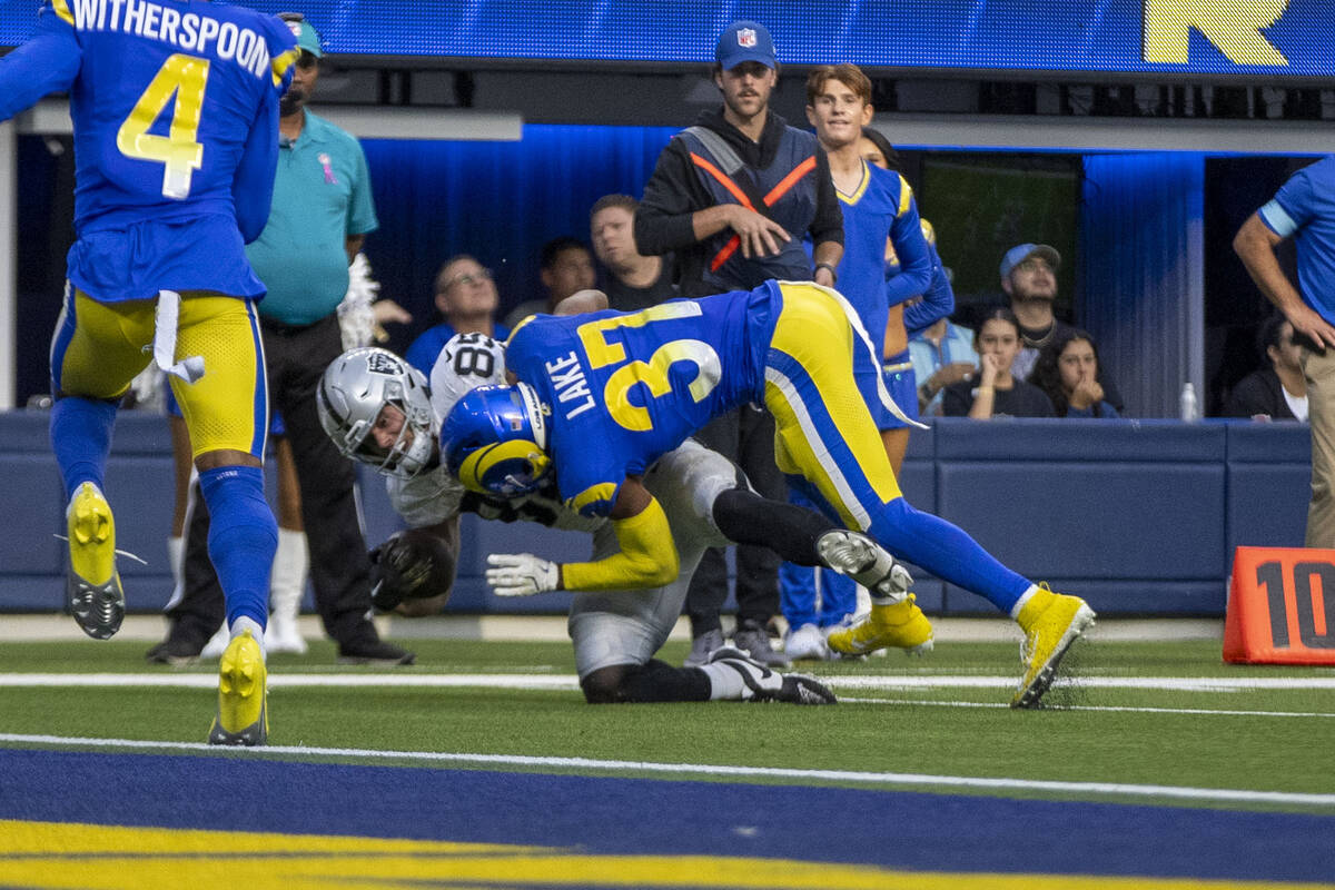 Los Angeles Rams safety Quentin Lake (37) tackles Raiders tight end Brock Bowers (89) short of ...