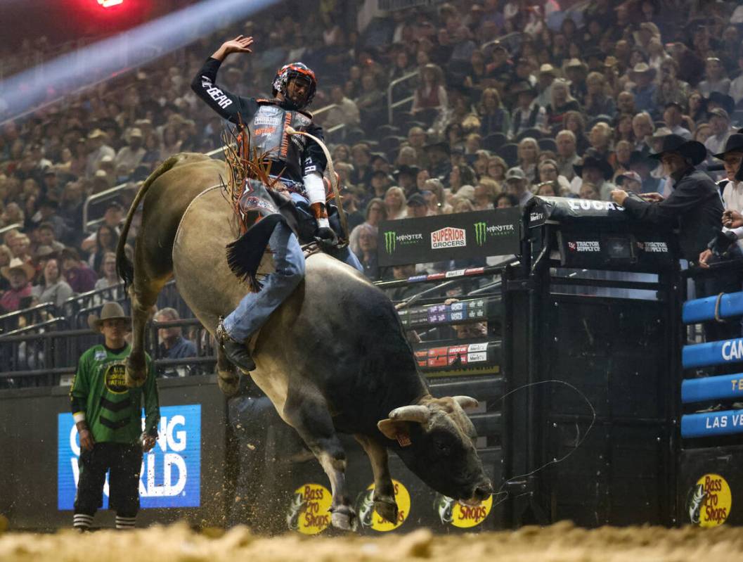 Kansas City Outlaws’ Sandro Batista rides a bull at the Professional Bull Riders Teams C ...