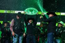 The Austin Gamblers’ Jose Vitor Leme holds the trophy as teammates open bottles of champ ...