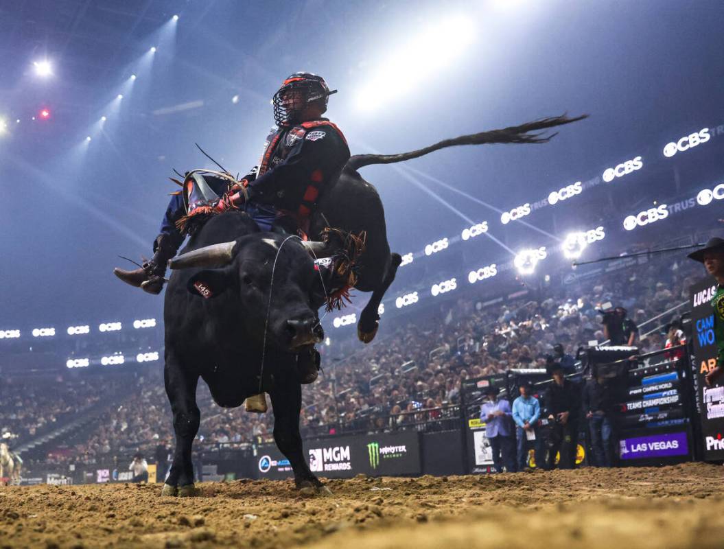 Kansas City Outlaws’ Brennon Eldred rides a bull at the Professional Bull Riders Teams C ...