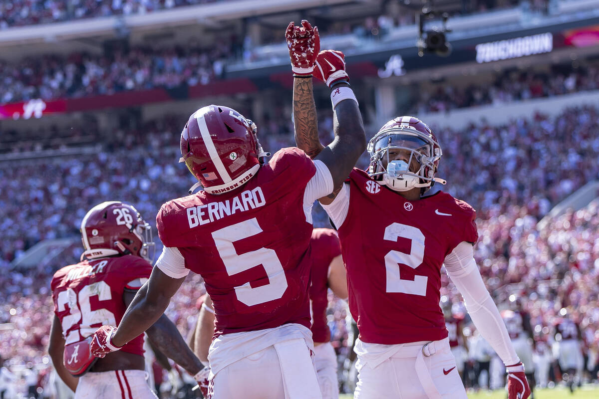 Alabama wide receivers Germie Bernard (5) and Ryan Williams (2) celebrate a touchdown by Bernar ...