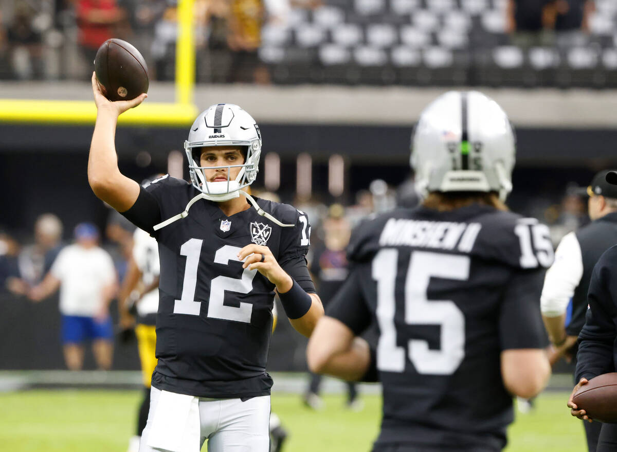 Raiders quarterbacks Aidan O'Connell (12) and Gardner Minshew (15) warm up before facing Pittsb ...