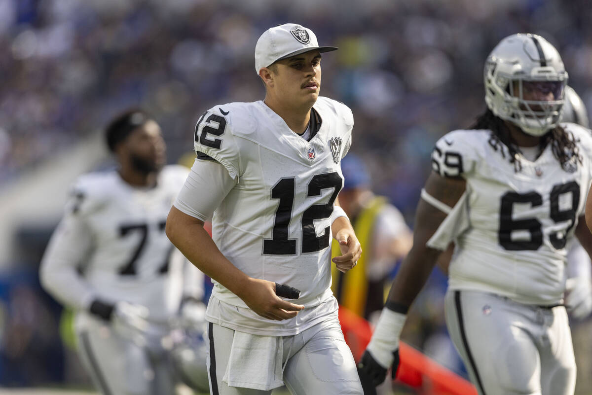 Raiders quarterback Aidan O'Connell (12) goes into the locker room with his right thumb taped d ...