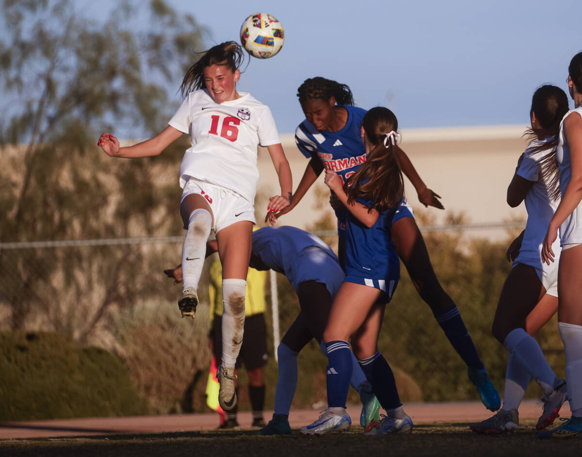 Bishop Gorman midfielder Amiya Warner (12) jumps to head the ball against Coronado defender Mia ...